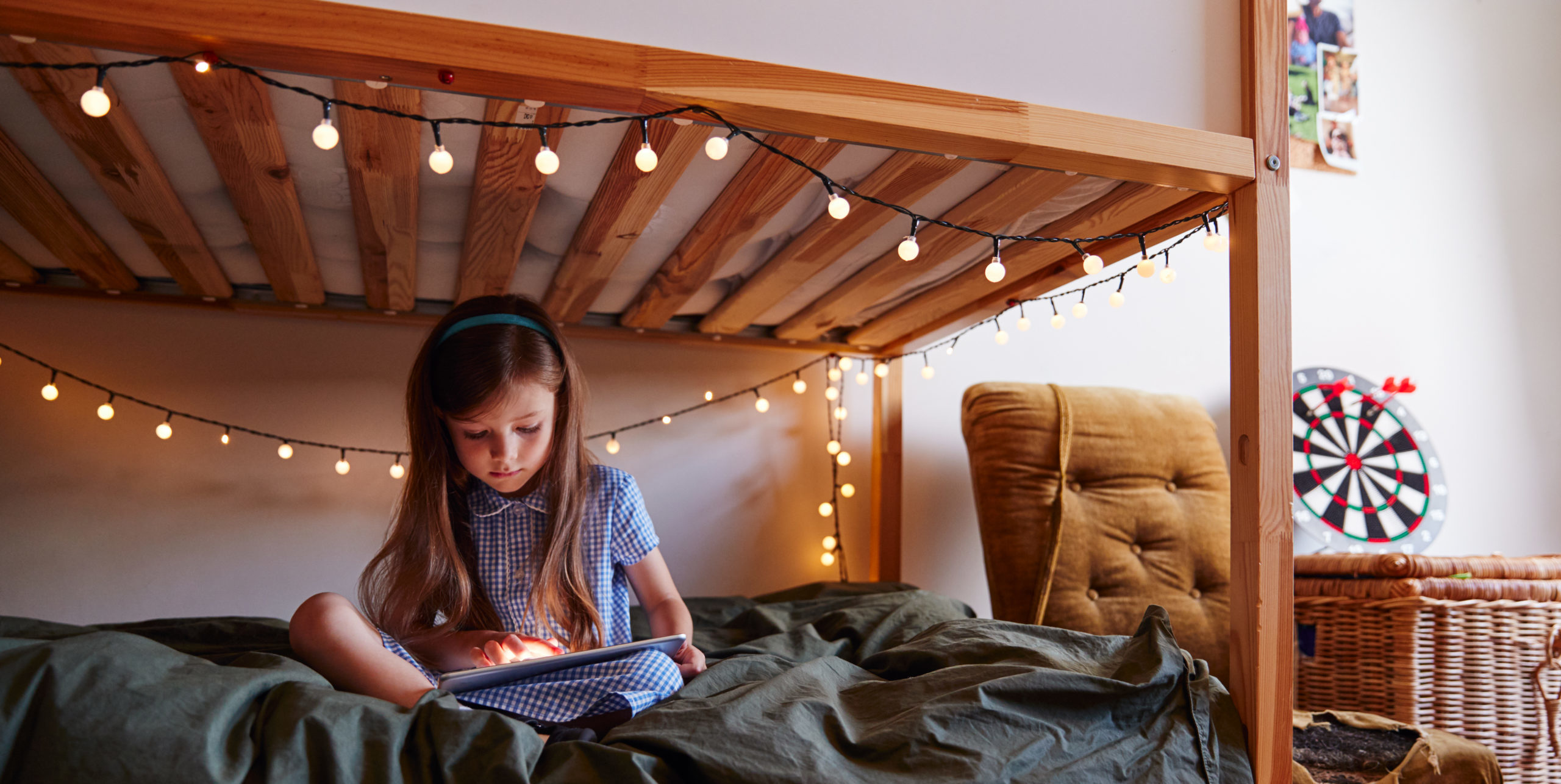 young girl sitting on bed at home decorated with f 7XRPWZB scaled e1609327795789